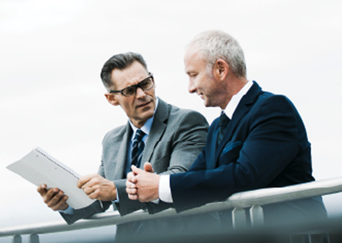 Two professionals reviewing a document.