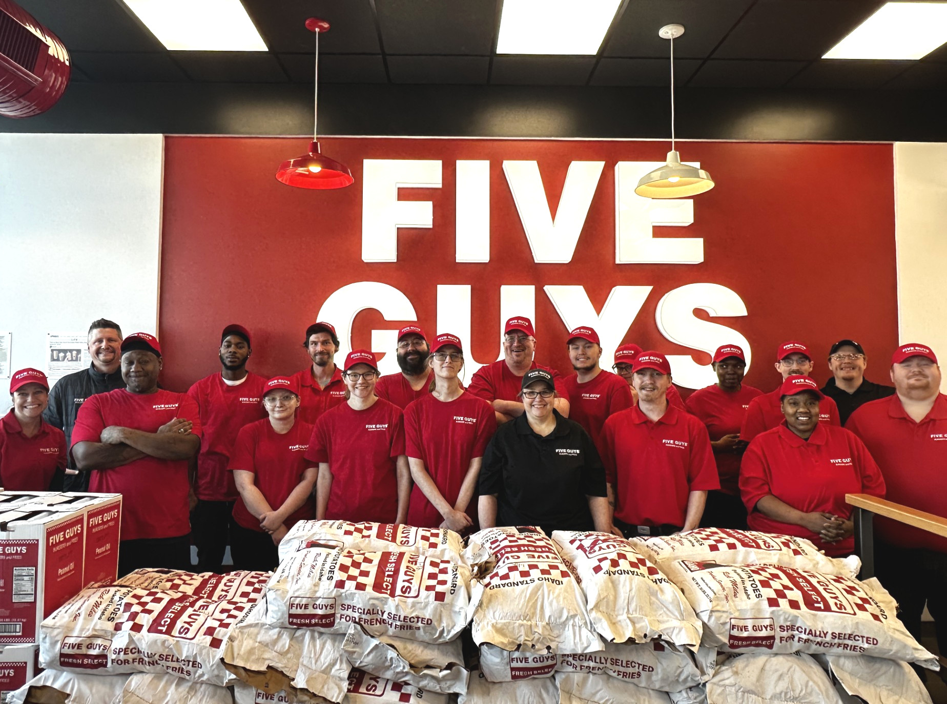 Crew members pose for a photograph in the dining room ahead of the grand opening of the Five Guys at 821 West Clairemont Avenue in Eau Claire, Wisconsin.