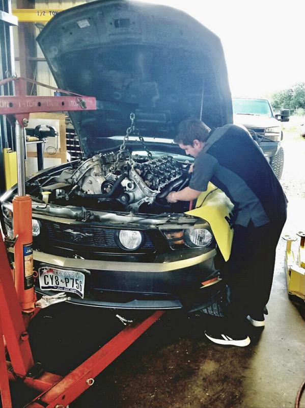 C H Auto Repair mechanics working on a vehicle.