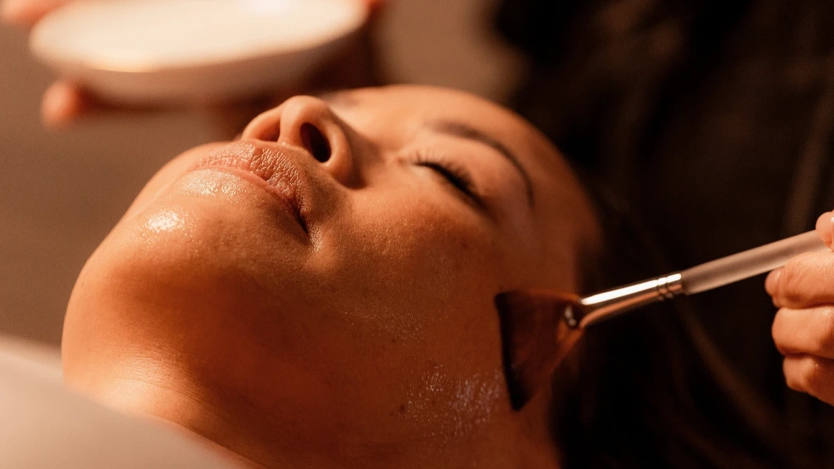 Professional facial treatment with serum application for Club members at luxury spa