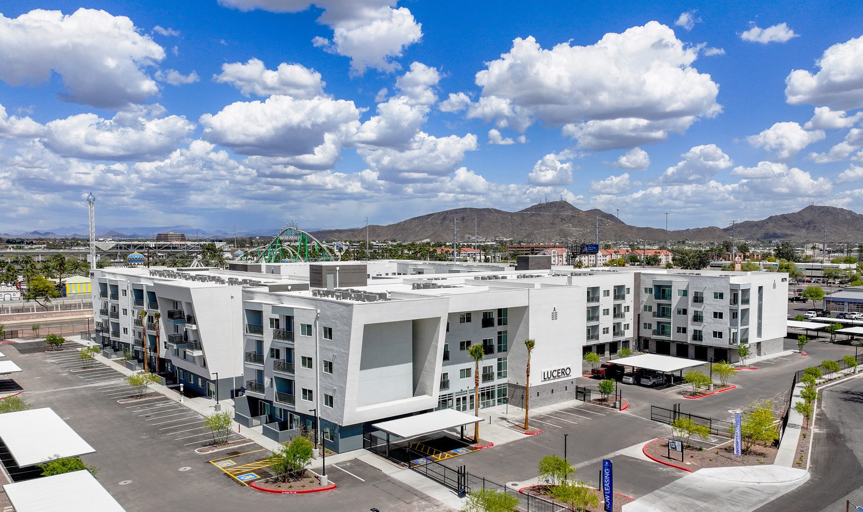 Modern apartment building exterior with parking area
