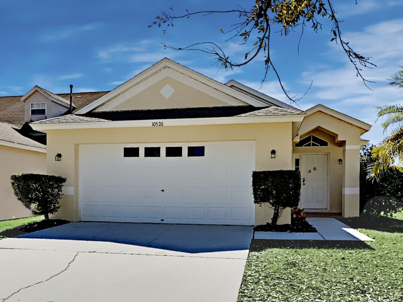 Beautiful home with a two-car garage and covered patio at Invitation Homes Tampa.