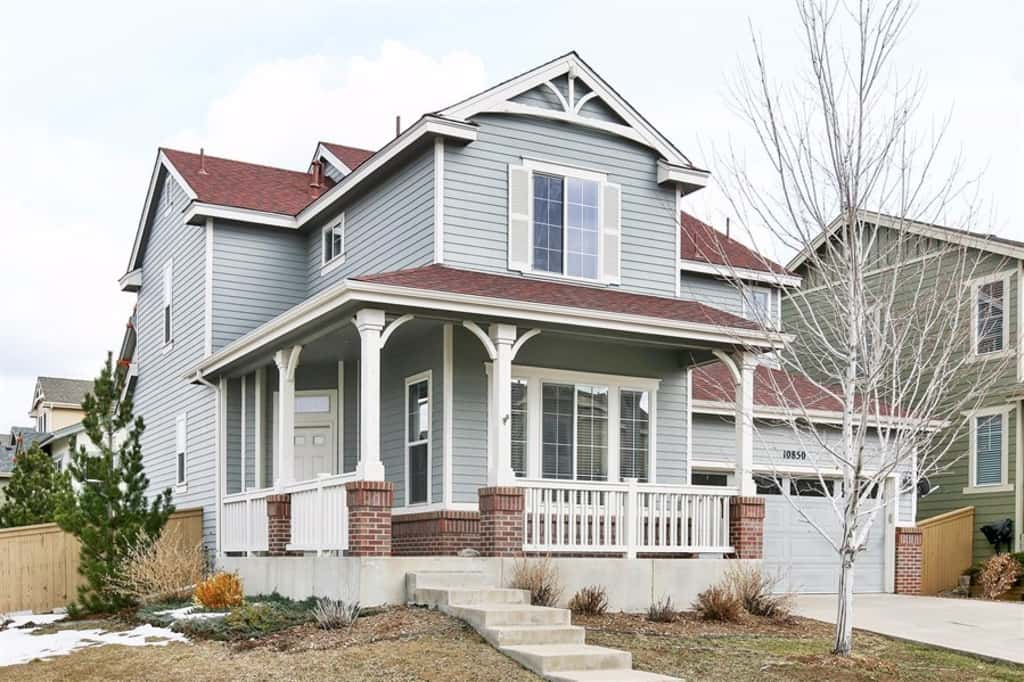 Beautiful front of home with a two-car and front patio at Invitation Homes Denver.