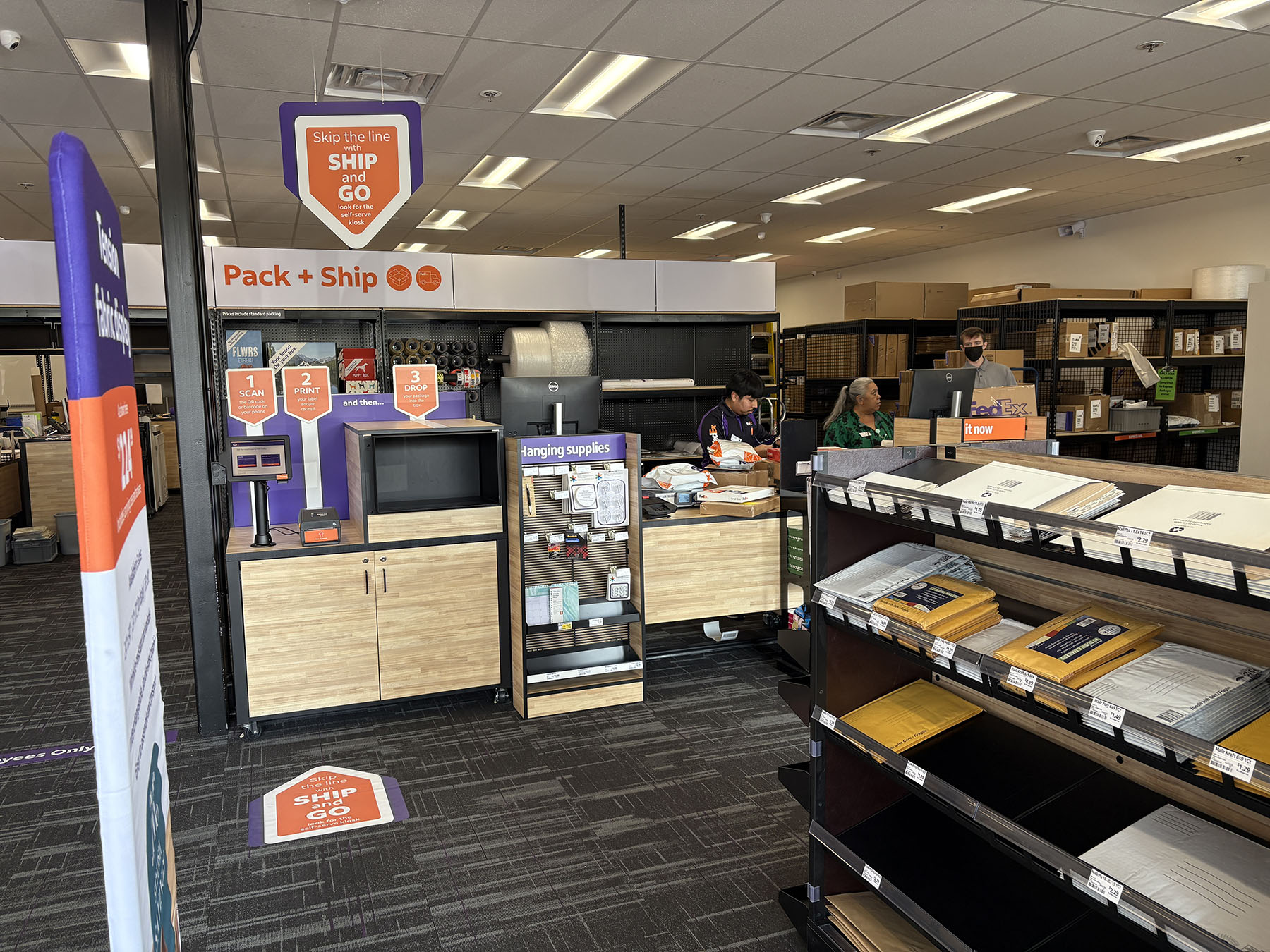 Pack and Ship Workstation Close-Up &ndash; Close view of Ship and Go kiosk with shipping supplies, boxes, and tools for secure packaging.