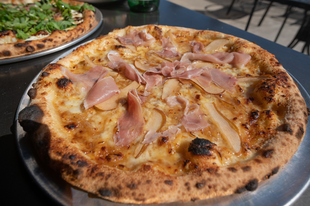 Airy wood fired crust  with delicious balance of Prosciutto, fig jam, caramelized onions, fontina and mozzarella. Ingredients shipped in from Italy for a truly authentic experience.