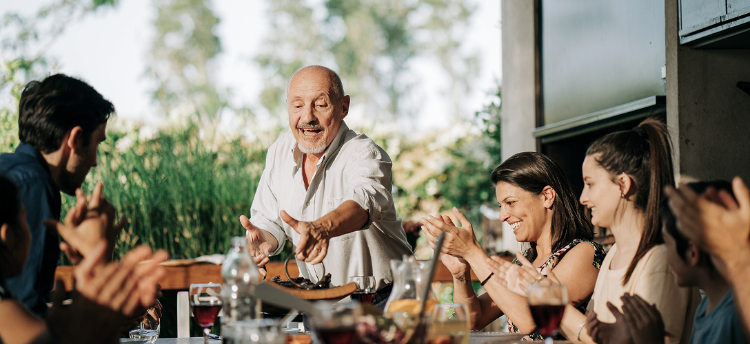 A multigenerational family eating dinner.
