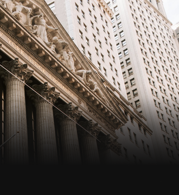 Close up of the Classical revival architecture, including sculptures and columns, of the New York Stock Exchange.