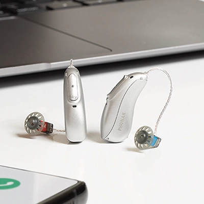 Phonak hearing aids sit on a desk in AudioNova hearing clinic in St Clair Shores, MI
