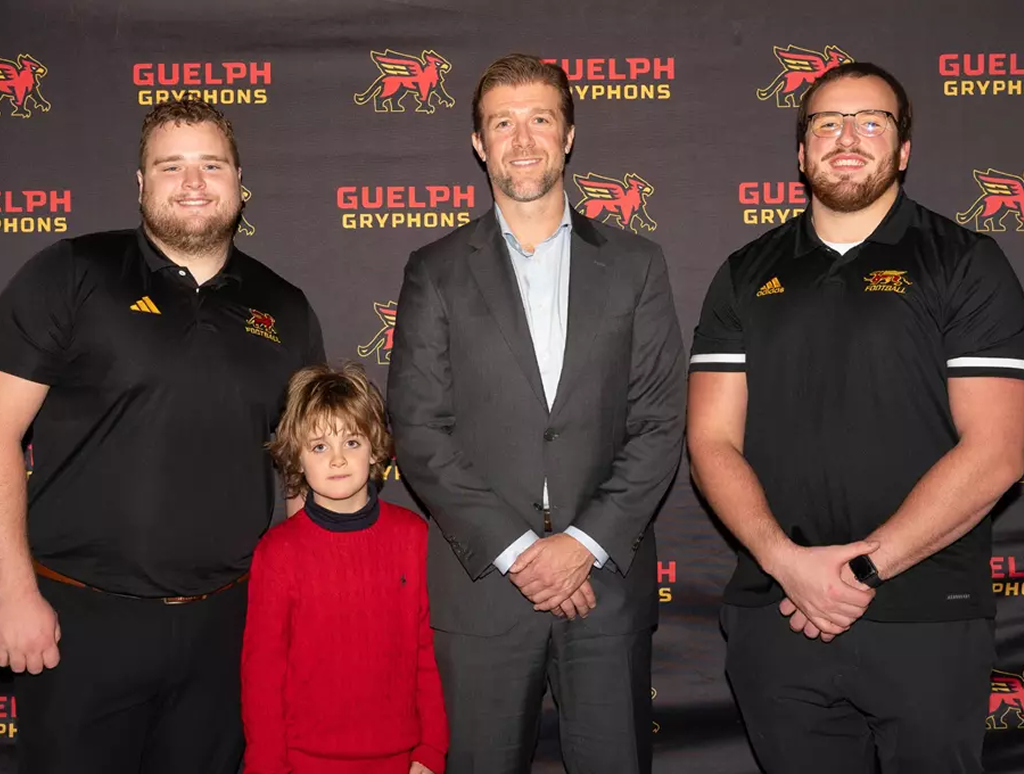 Craig Thompson with football scholarship recipients.