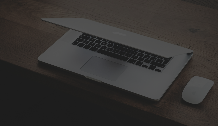 A half-open laptop on a desk.