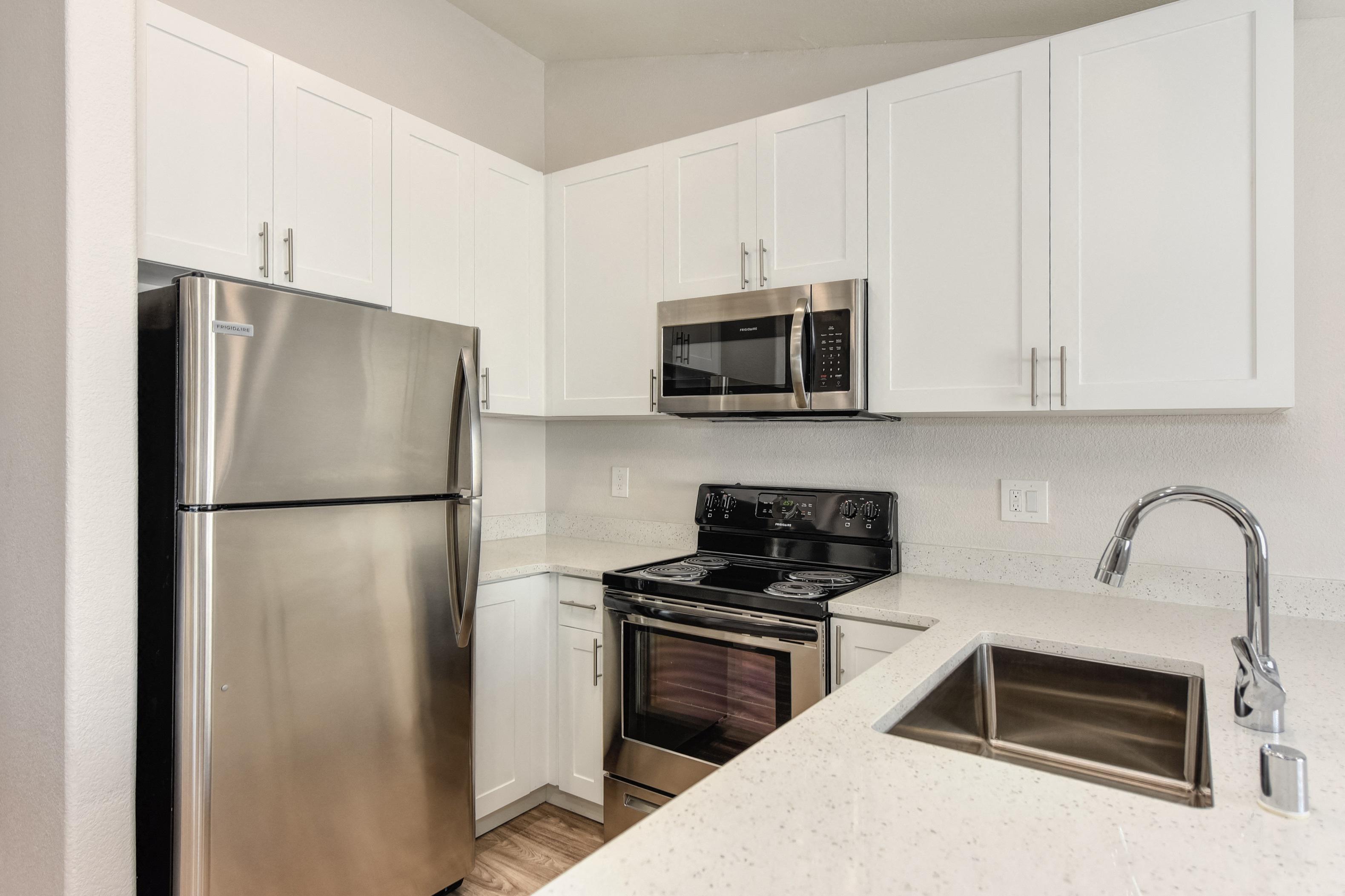 Kitchen with Refrigerator at The Legacy Apartments
