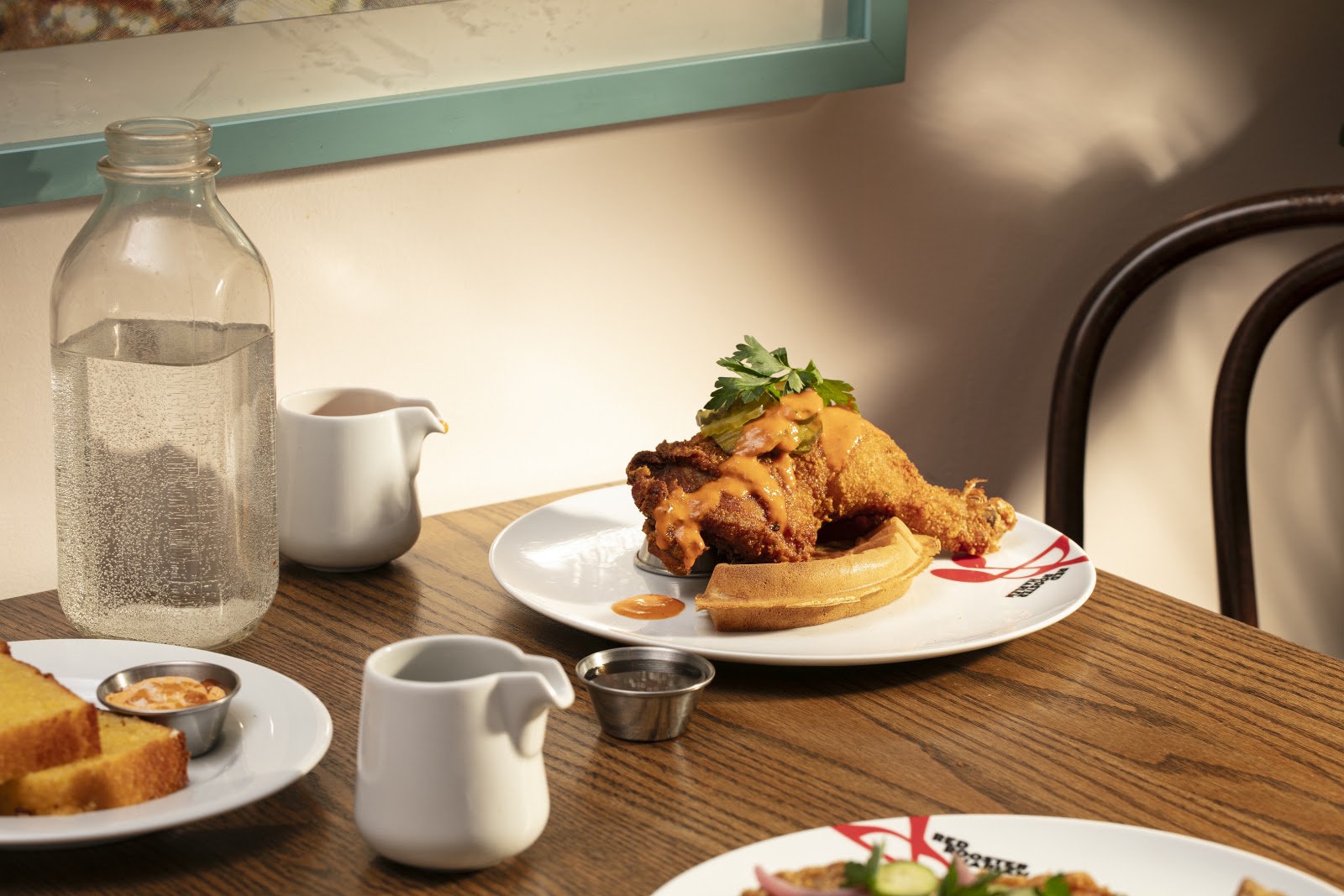 Yep! Chicken & Waffle at Red Rooster Harlem, a fried chicken leg with maple hot sauce and pickle. Served in Harlem.