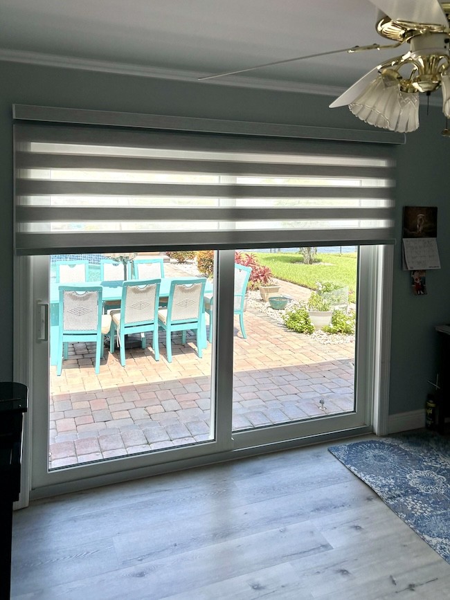 Experience the best of both worlds with dual sheer shades! Notice how these dual sheer shades gently filter the sunlight in this local Vero Beach home, creating a soft glow that perfectly complements the serene coastal view beyond.