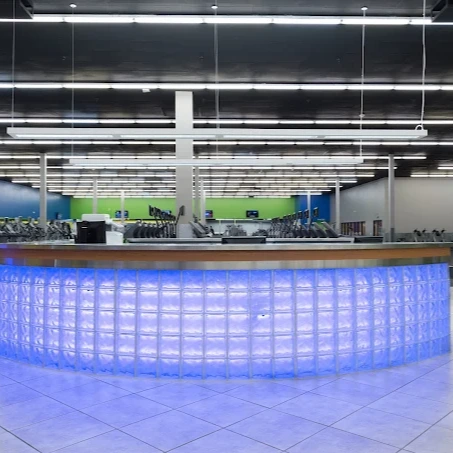 10GYM South Tulsa front desk and lobby area with bold blue accent lighting.