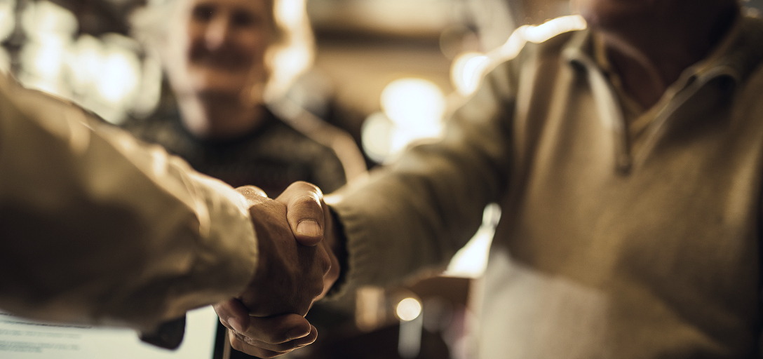 Close-up of two people shaking hands.