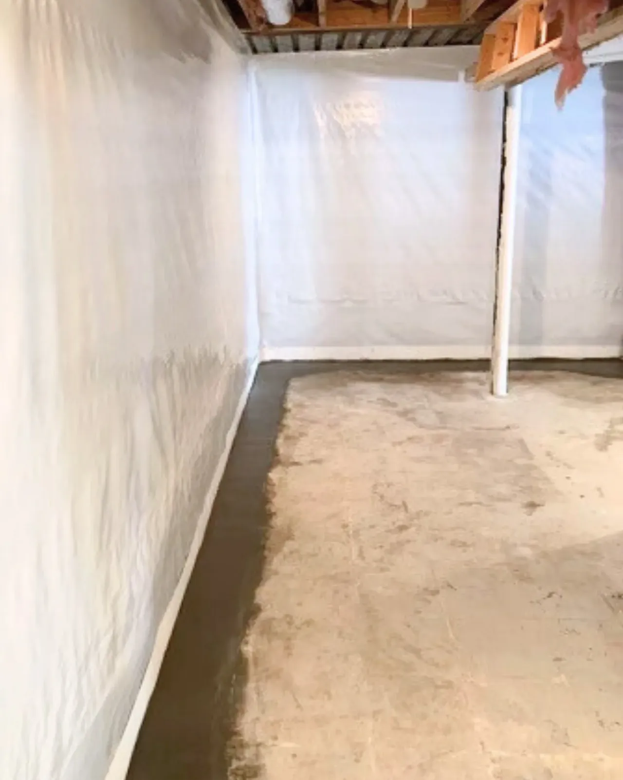 Professional basement waterproofing system installed with durable vapor barrier walls and interior drainage channel. Clean, moisture-controlled basement space designed to prevent water intrusion, reduce humidity, and protect structural integrity long-term.