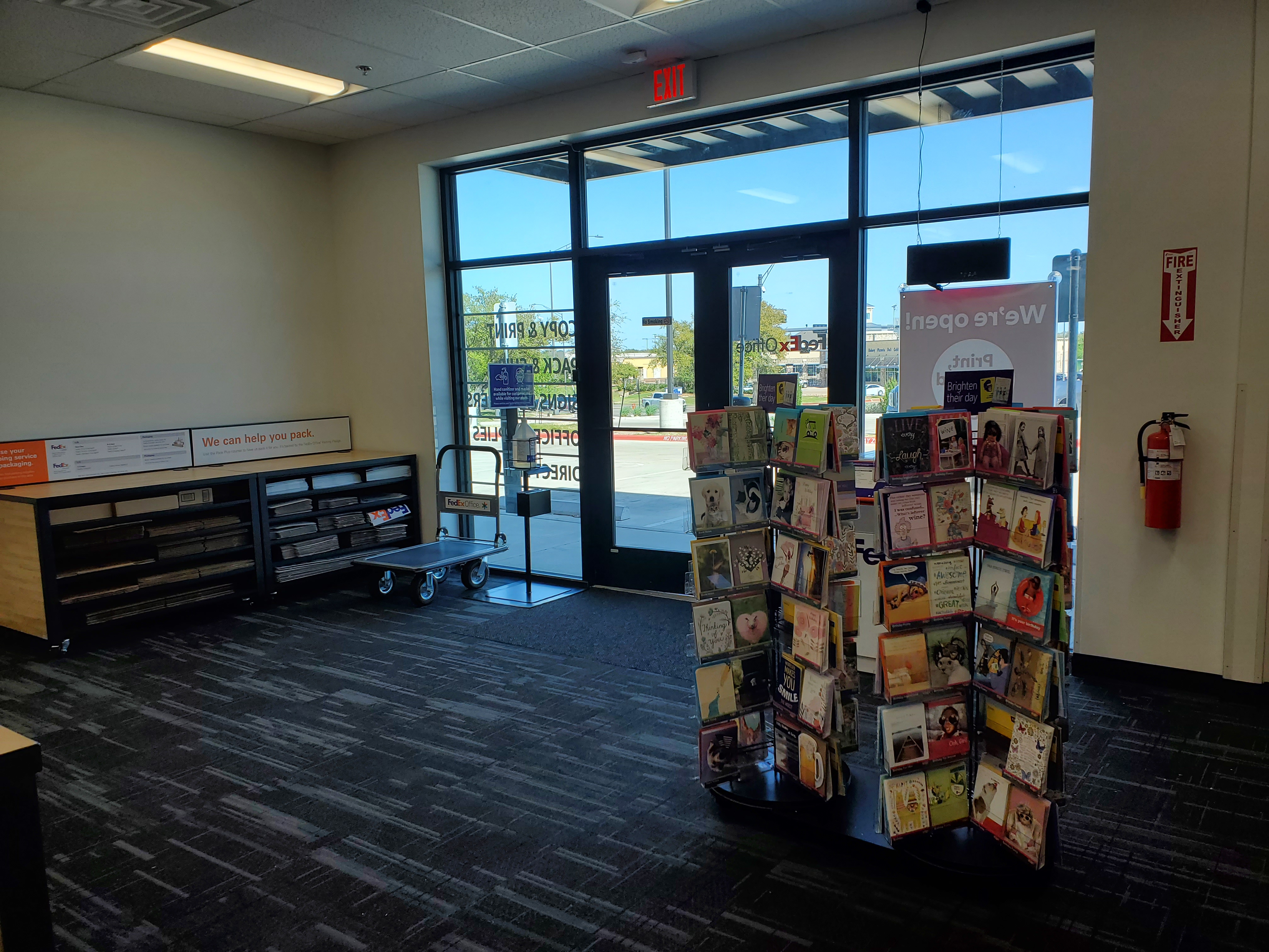 Front entrance and lobby area of FedEx Office Print and Ship Center in College Station Texas with access to printing and shipping services.
