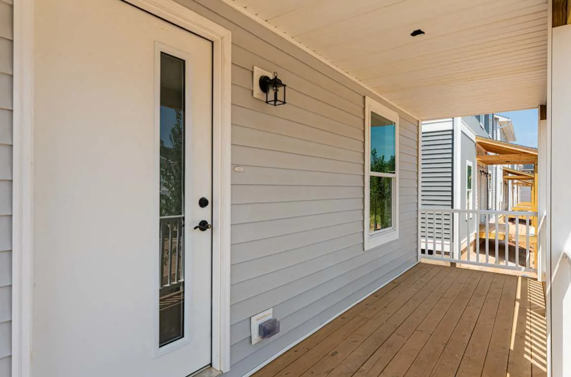 The porch area at Belle Meadow Homes offers a charming space to relax and unwind.