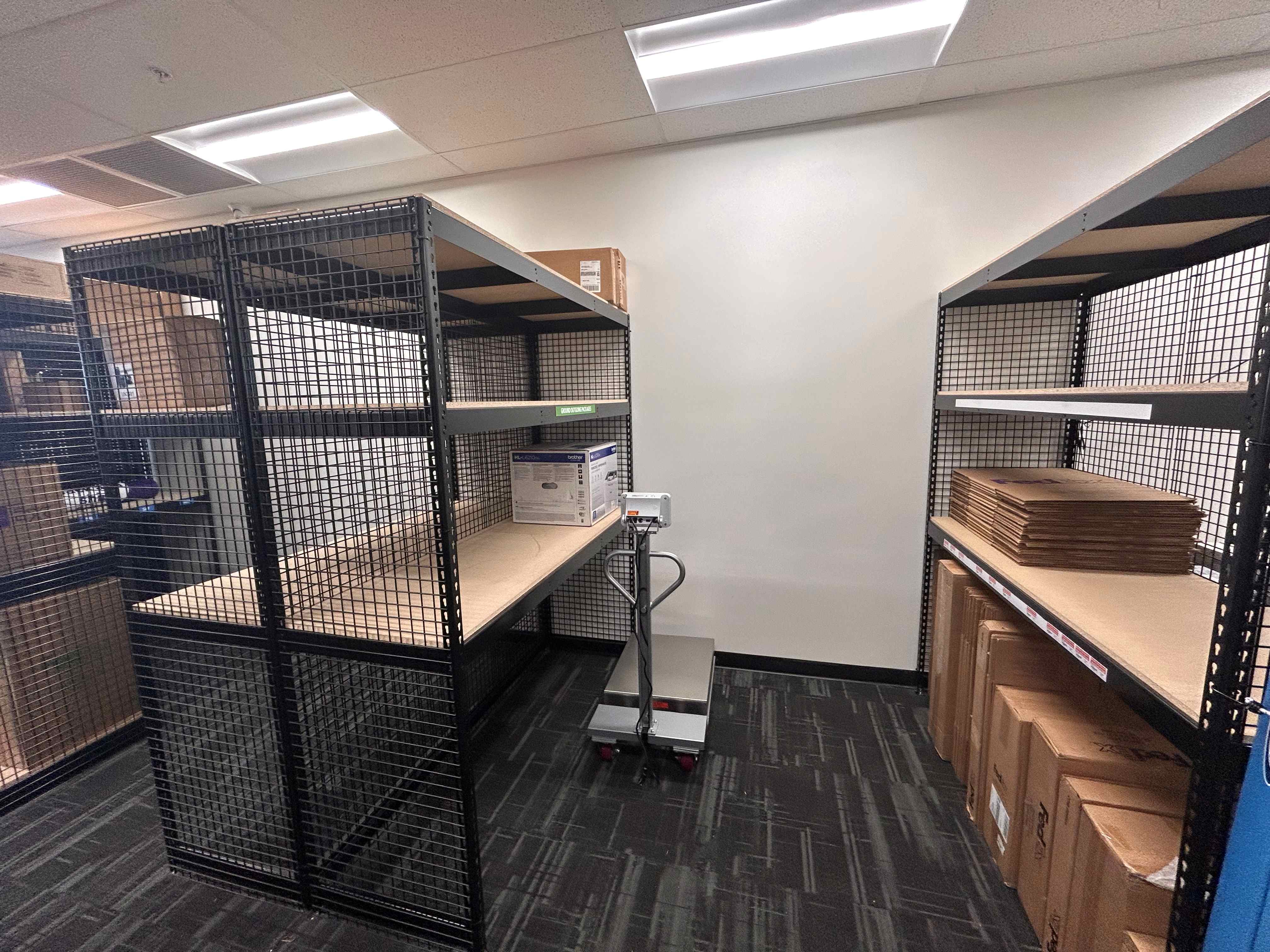 Secure, caged shelving units for holding customer packages and completed orders safely at the Mesa,  