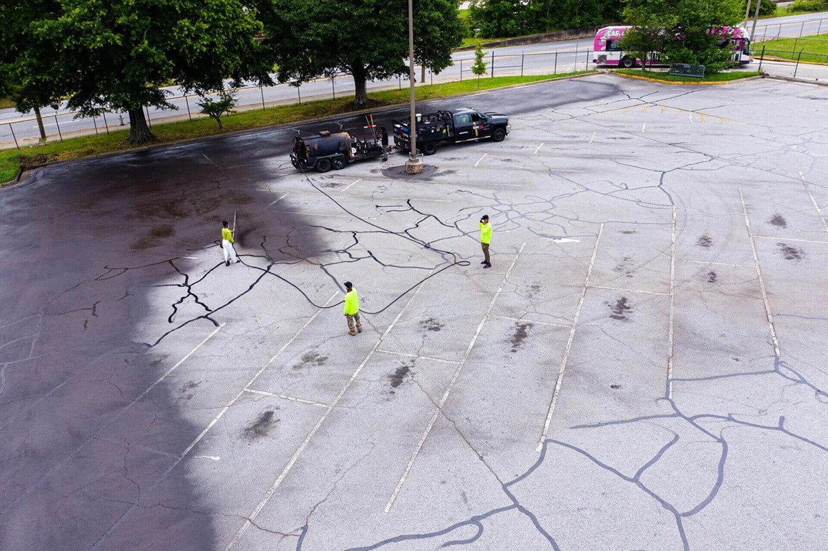 Blackjack Paving crew performing sealcoating service for a parking lot.