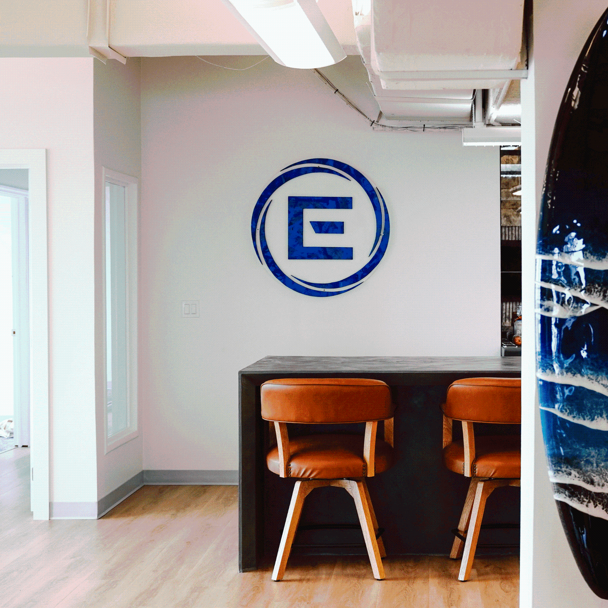 Engage360 logo on wall by kitchen island and stools
