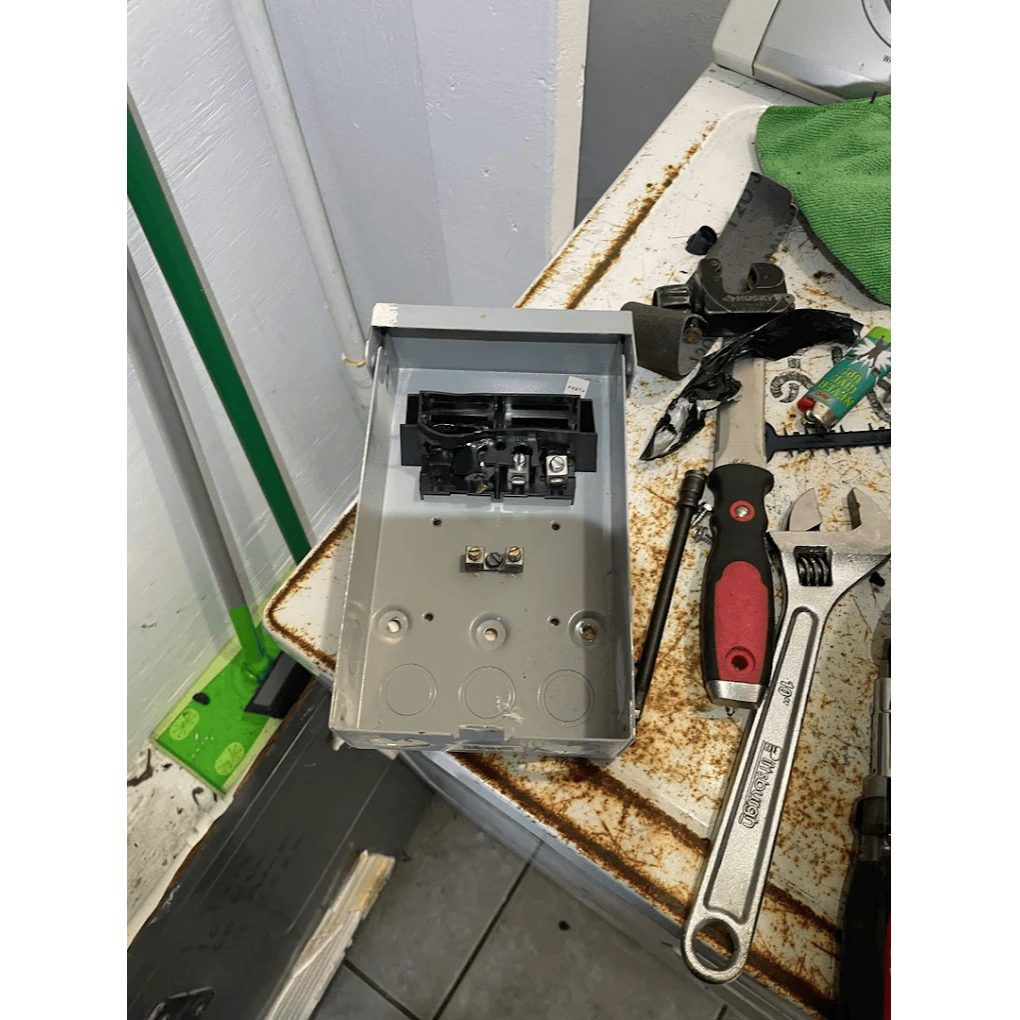 HVAC technician installing electrical disconnect box for air conditioning system repair and safety by Gotcha Heating and Air Inc in Spring Hill Florida