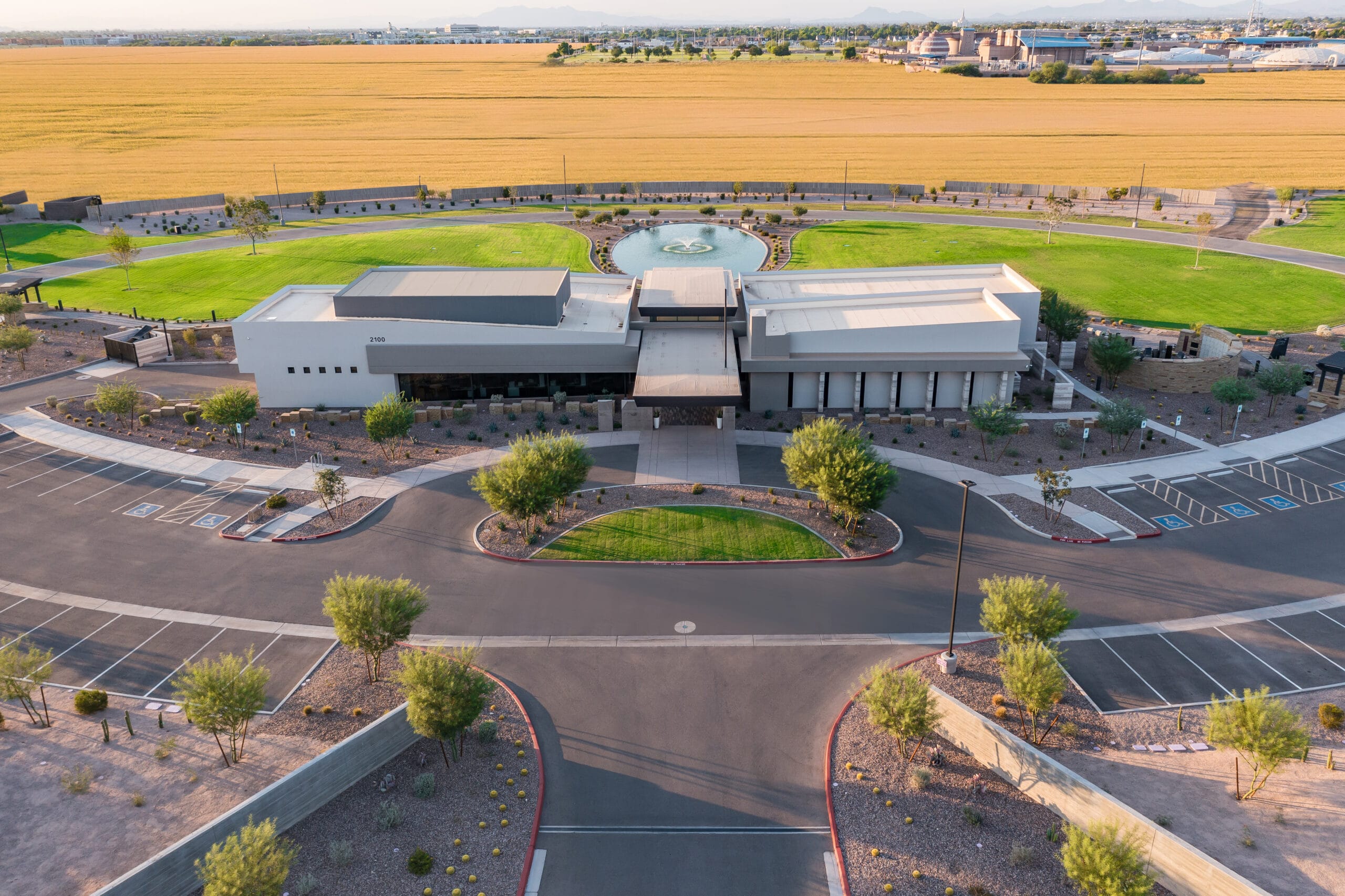 From the air: the entrance drive off Queen Creek Road leads to the main building, with the fountain and burial lawns beyond.