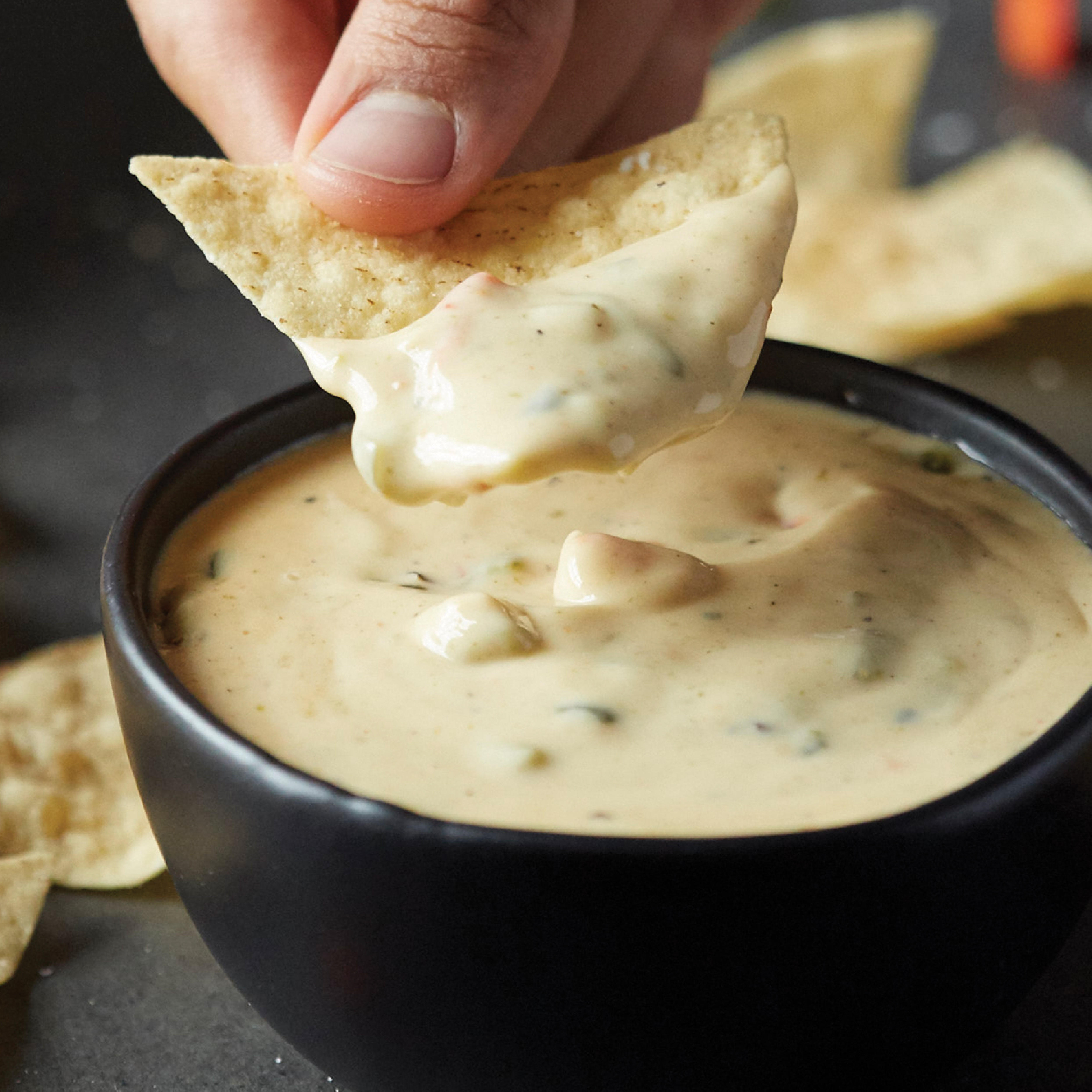QDOBA's signature 3-cheese queso pairs perfectly with fried in-house tortilla chips or on any entrée at no additional charge!
