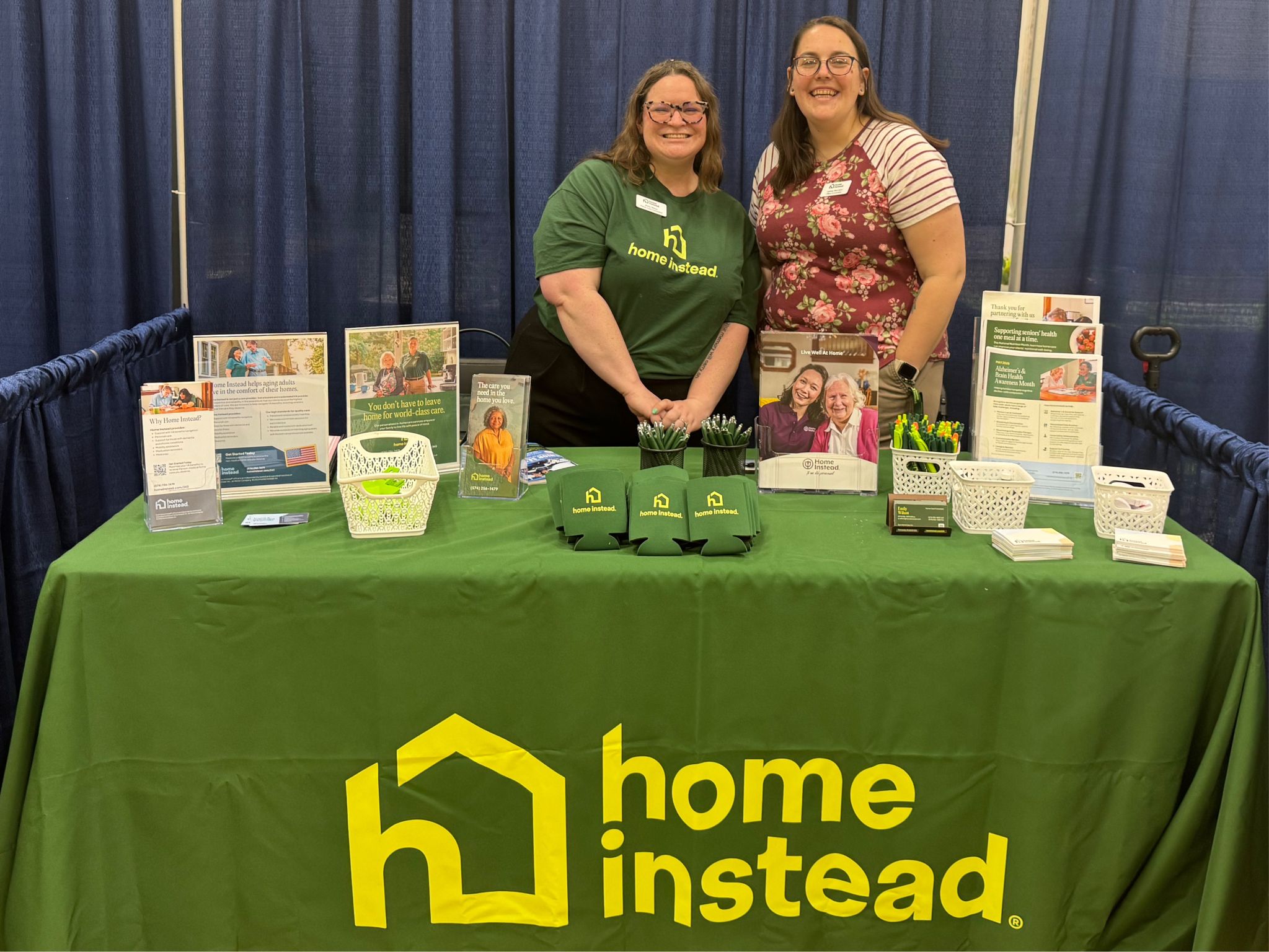 Home Instead team members engaging with families at a community event.