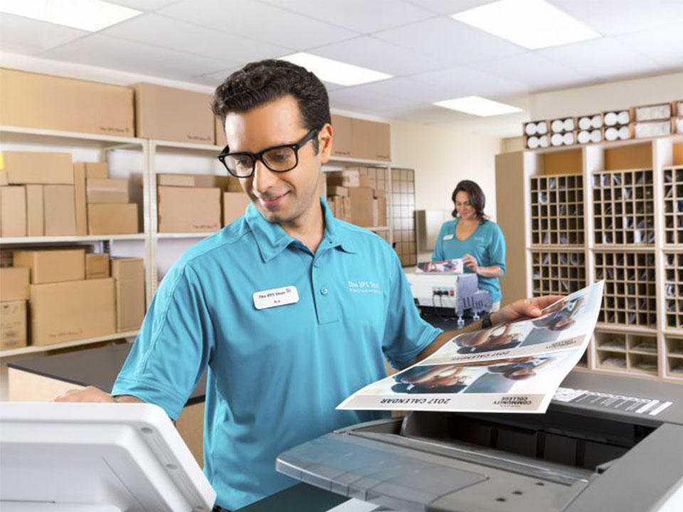 man standing at printer