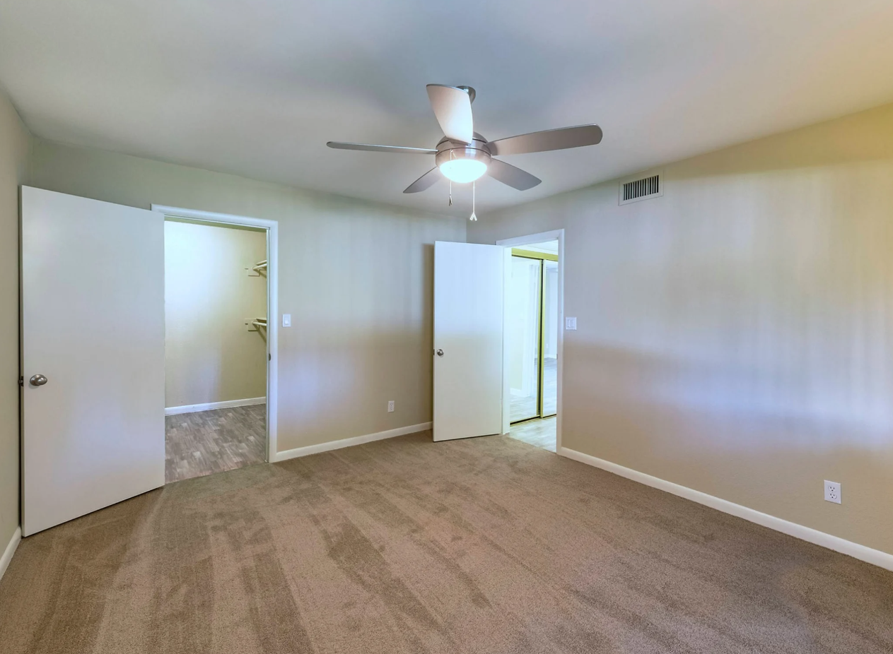 Bedroom with Plush Carpeting and a Ceiling Fan