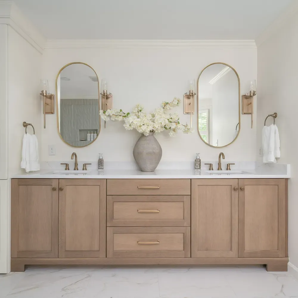 High-end bathroom remodel near Badin Lake, North Carolina with custom wood vanity, dual mirrors, and modern fixtures. This bathroom renovation reflects quality craftsmanship and attention to detail from an experienced remodeling contractor.