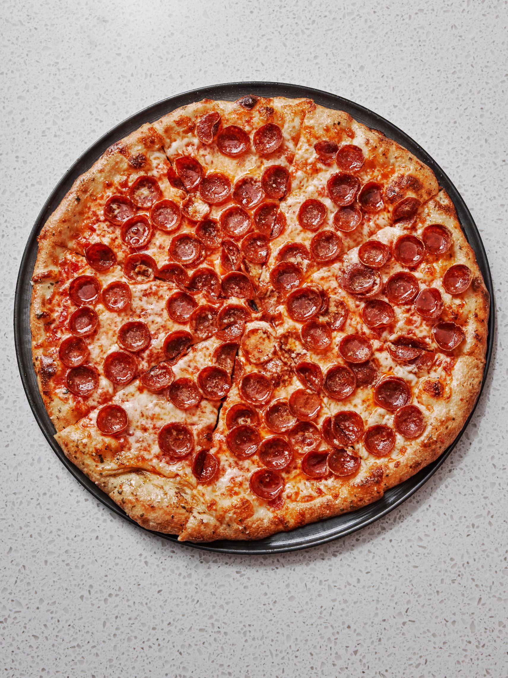 Red Sauce, Pepperoni Cups, Mozzarella, Hot Honey pizza at Islamorada Pizza Co.