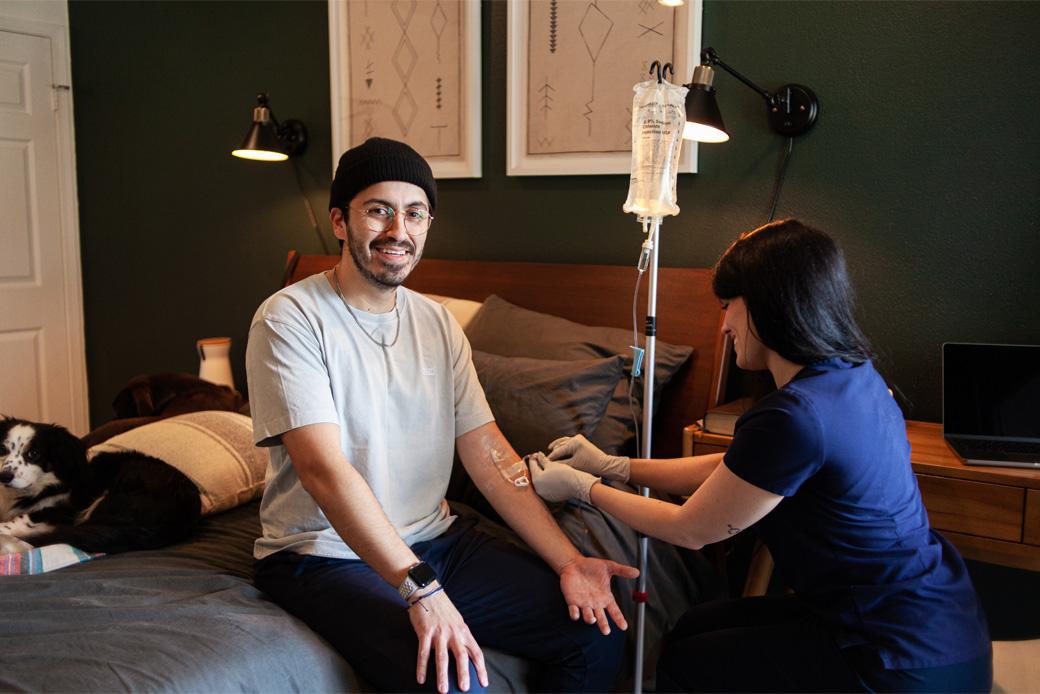 Man receiving mobile IV therapy at home in Los Angeles from a professional nurse