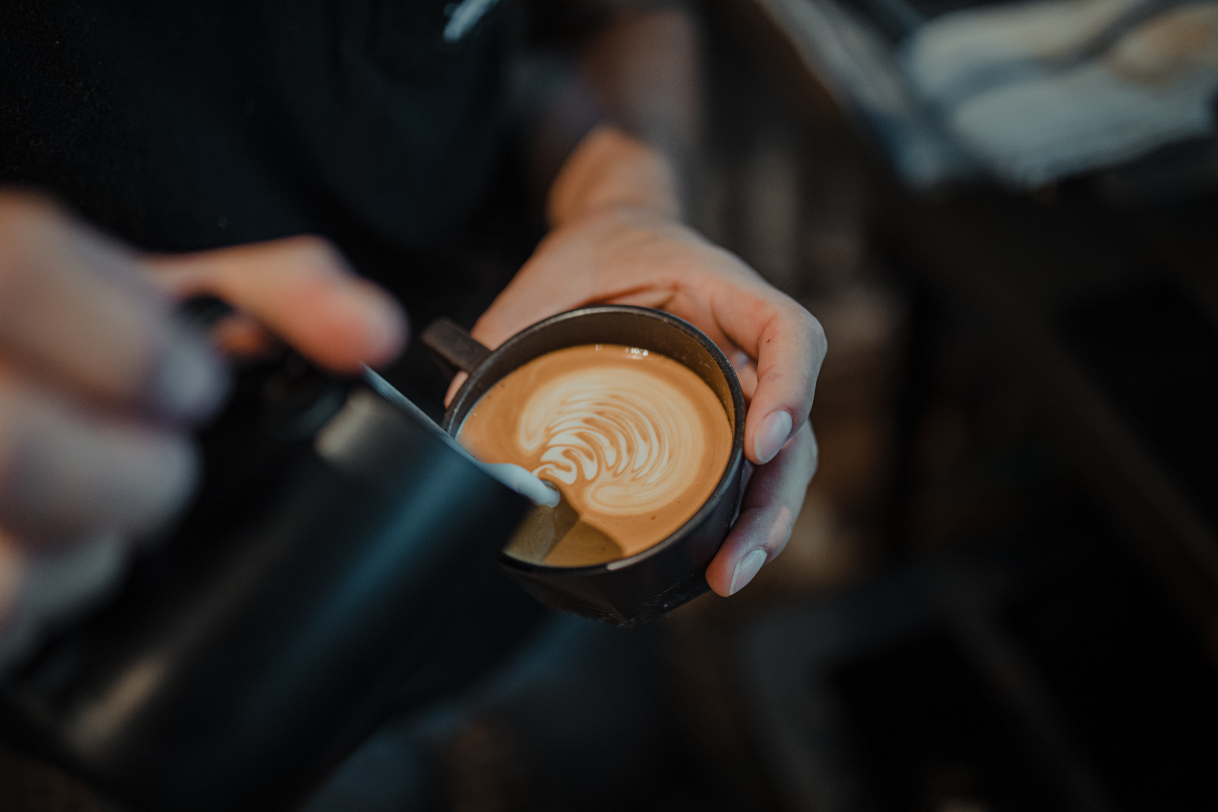 Latte art at Buzz & Bustle, a specialty Dallas coffee shop at The Village Dallas.
