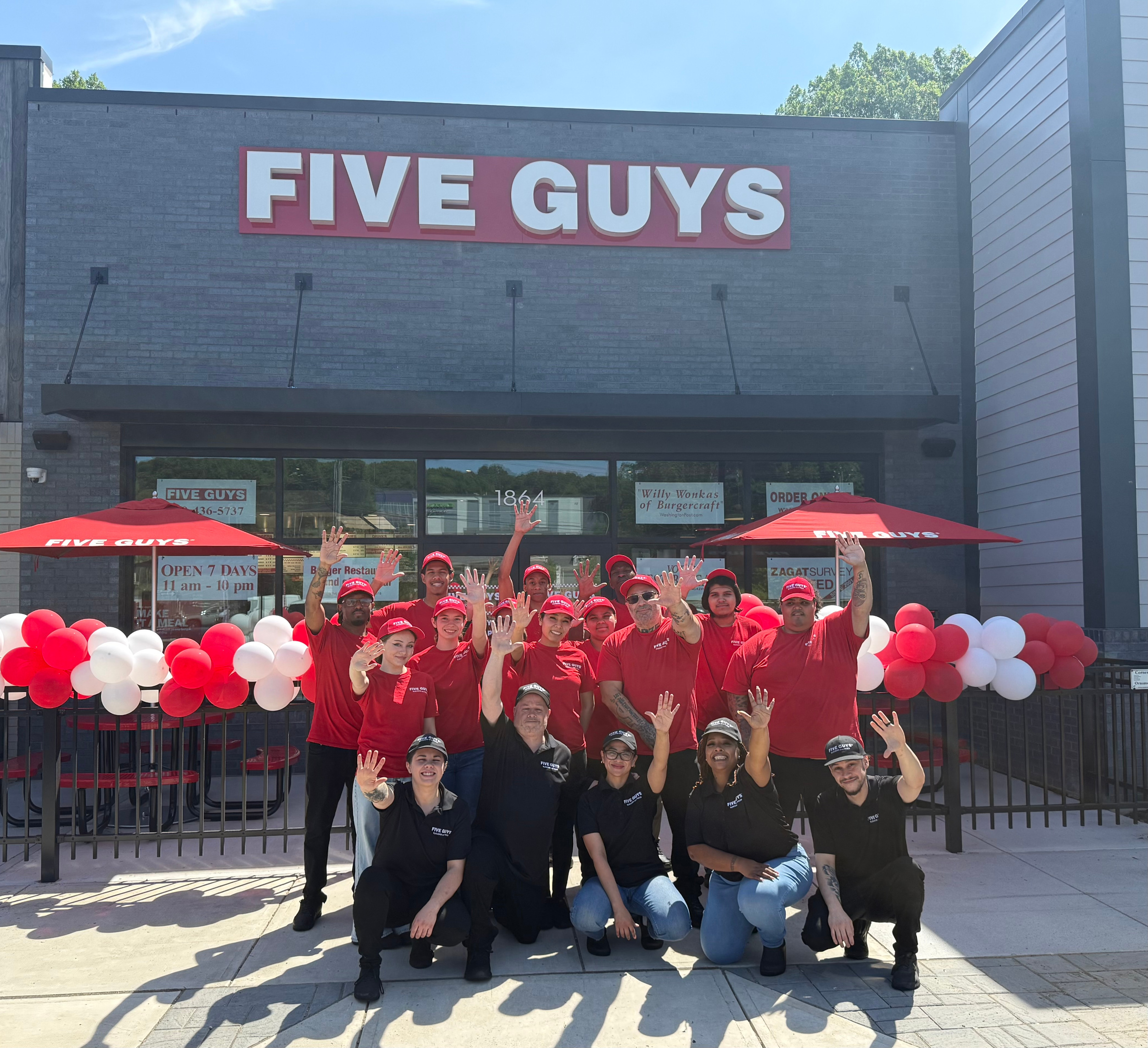 Crew members pose for a photograph outside of the Five Guys restaurant at 1864 Berlin Turnpike in Wethersfield, Connecticut.