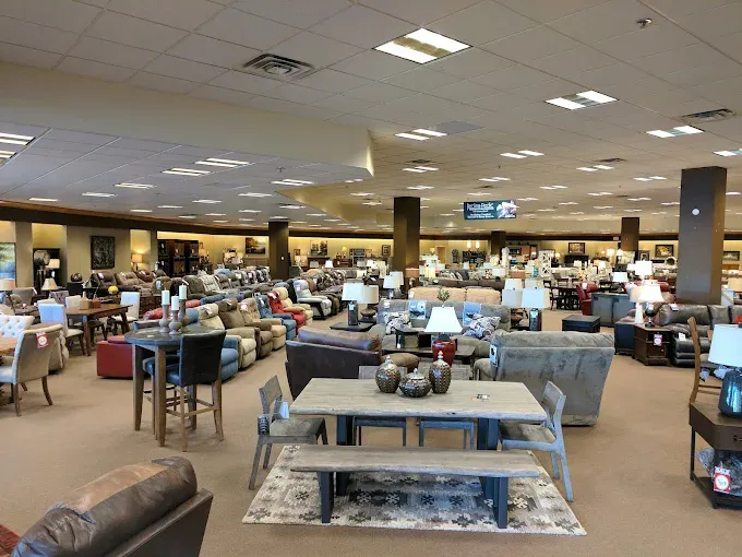 Neill&rsquo;s Homestore showroom featuring a wide selection of living room furniture, dining sets, lamps, accent tables, and home d&eacute;cor arranged throughout a large retail space.