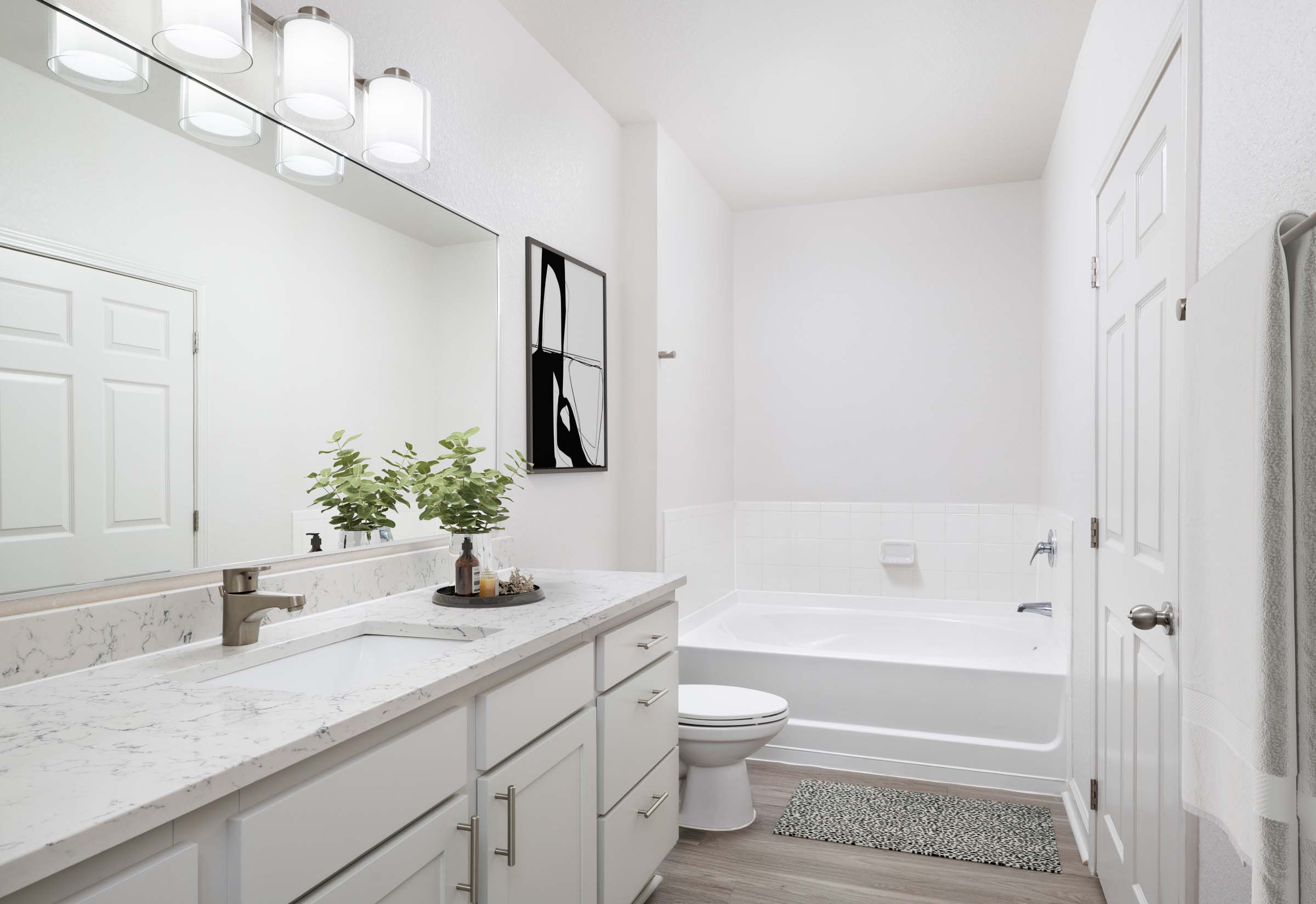 Camden Visconti apartment home primary bathroom with quartz countertops and bathtub.