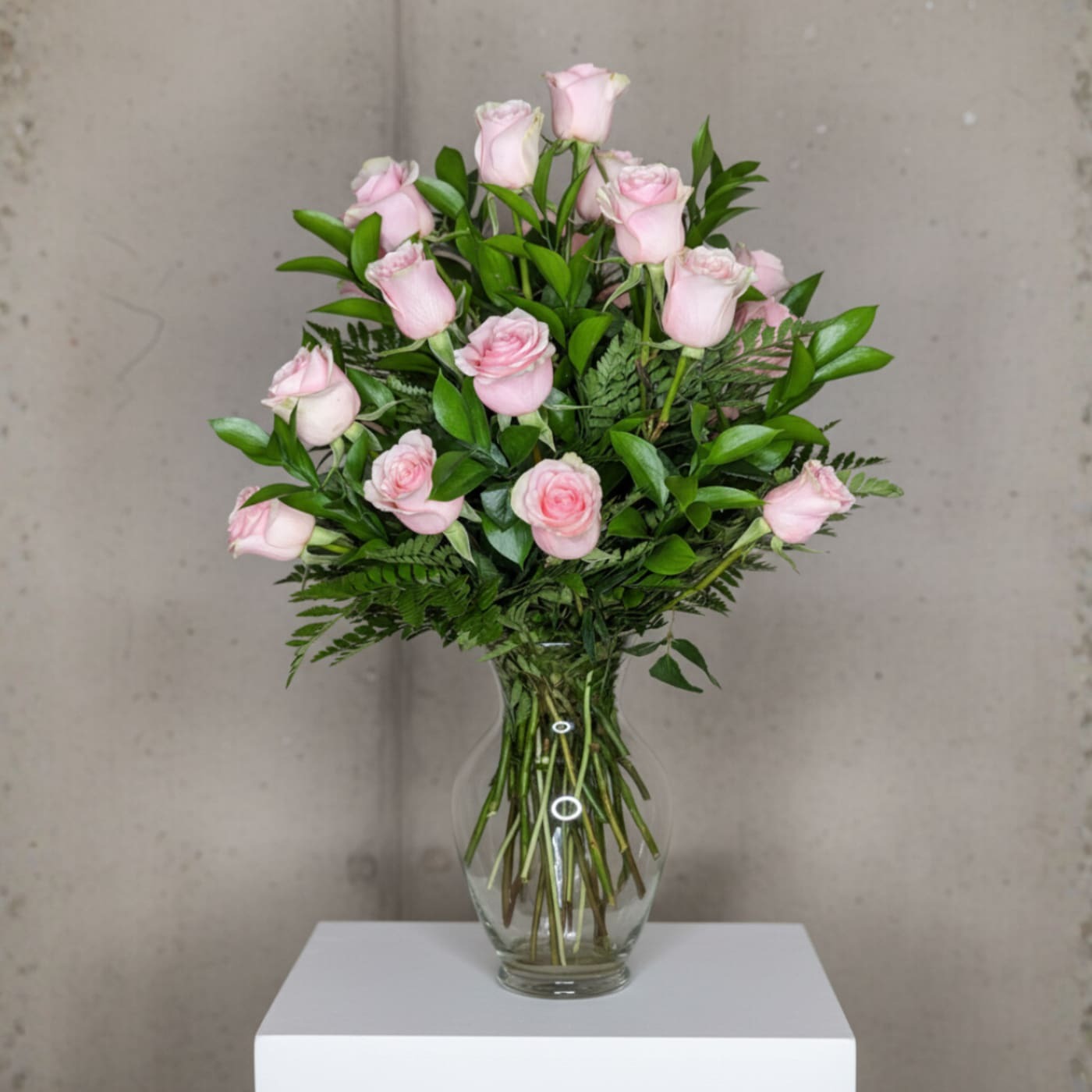 A breathtaking display of 25 soft pink roses arranged with lush greenery in a classic glass vase. This design is perfect for expressing love, admiration, or simply adding a touch of elegance to any space.
Premium: 35 soft pink roses