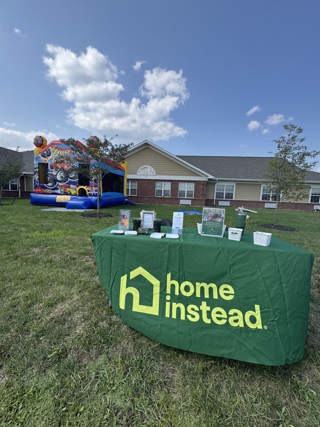Home Instead booth set up at a local community event to provide resources for families.