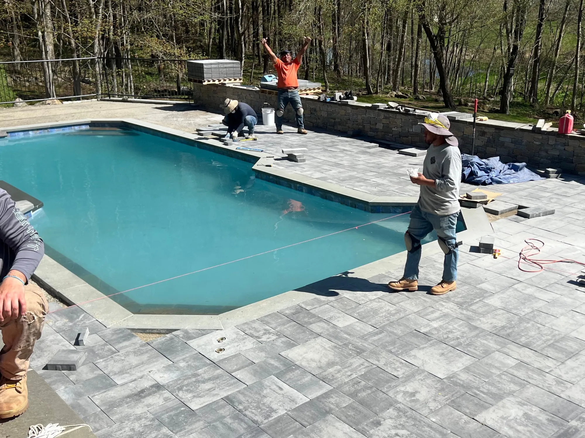 Laying pavers with grid lines for precise alignment - Craftsmanship & Process by General Masonry LLC.