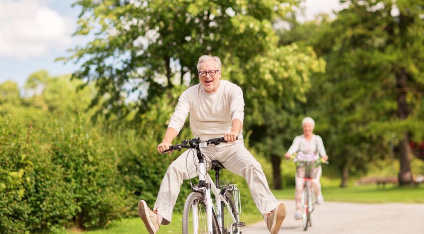 A senior couple riding bikes.