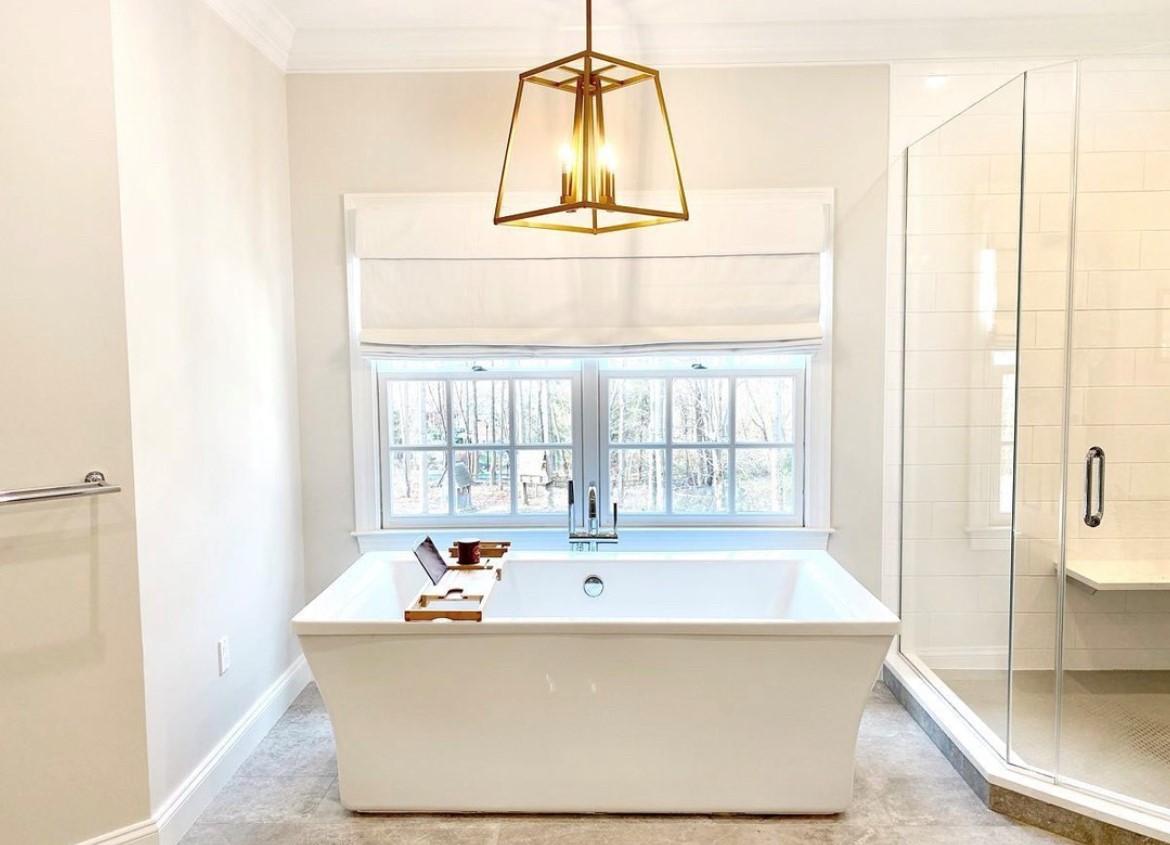 Soften your bathroom windows with Roman Shades for your own personal spa retreat. The roman shades of Budget Blinds of Rockwall, Terrell, and Greenville showcase soft folds of premium fabric that gently cascades showcasing beautifully diffused light.