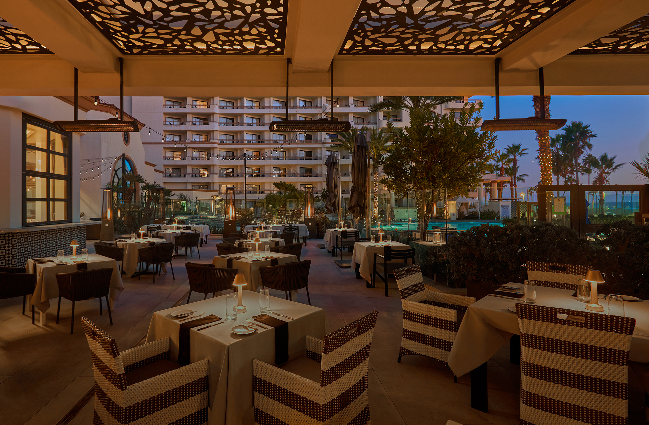 Outdoor seating area with Pool and Ocean View at Henry's Coastal Cuisine