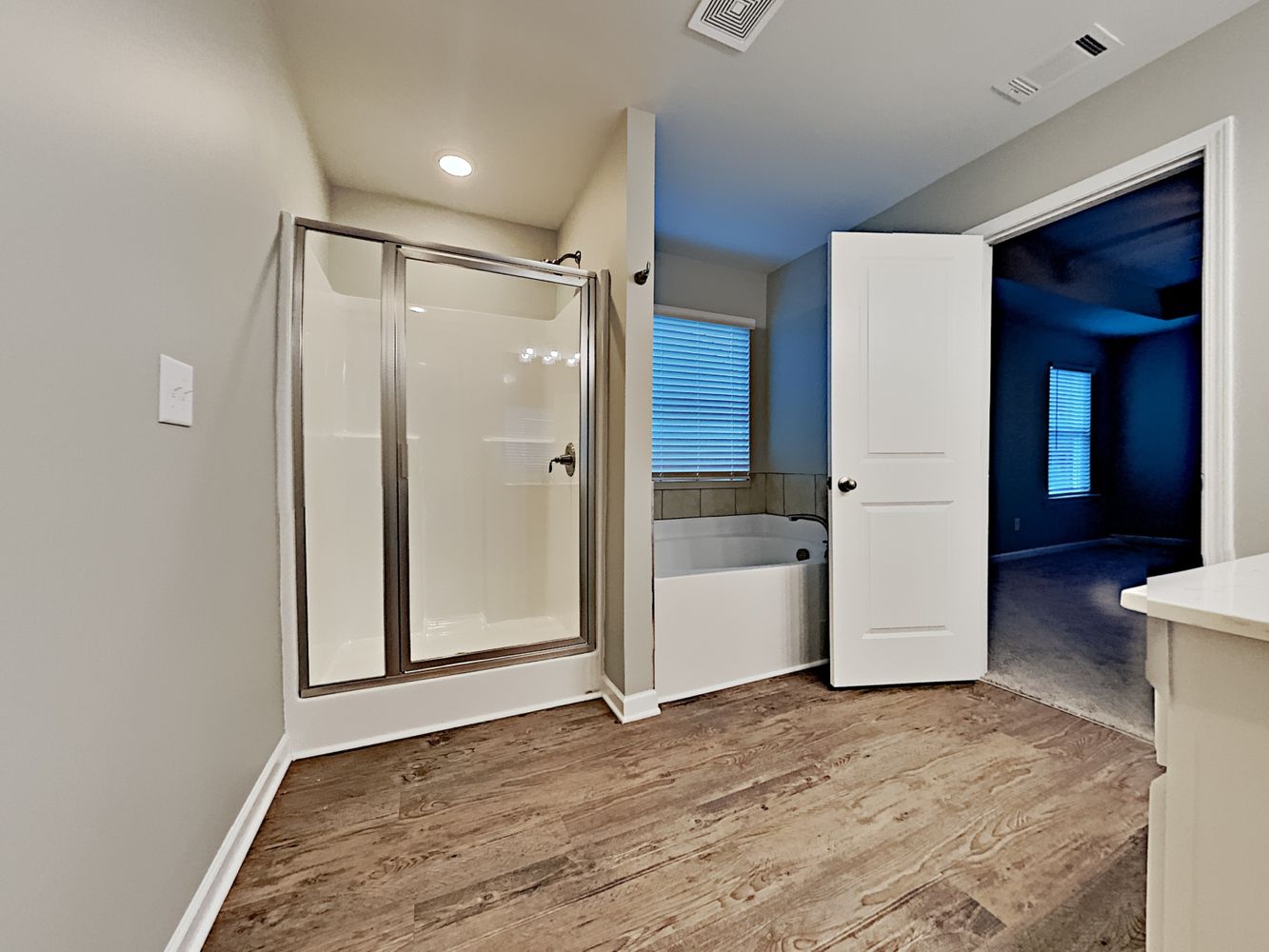 Spacious primary bathroom with garden tub and separate shower at Invitation Homes Atlanta.