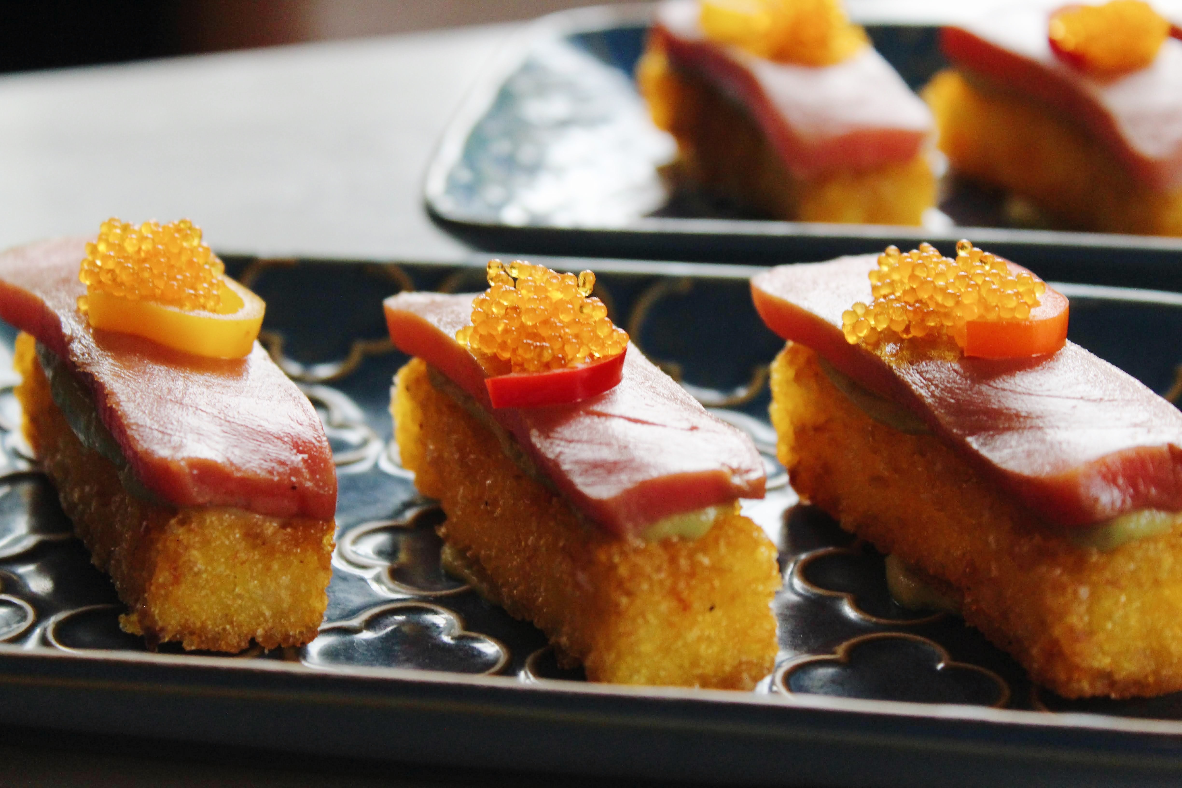 Tuna Crostinis — marinated tuna over golden crisp bites, crowned with citrus fish roe and pickled Fresno chilis. Pick three or six.