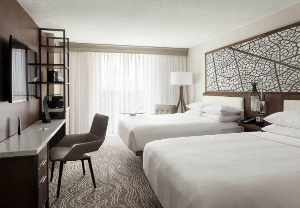 In addition to two queen beds, these hotel rooms offer a workspace and a flat-screen TV.