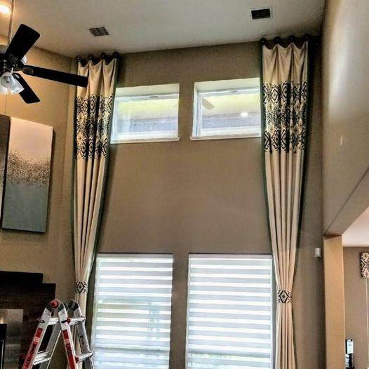 Do you want to spruce up your large windows? If so, these 2 Story Drapery Panels with patterned fabric inserts and tiebacks over Transitional Illusion Shades in Sugar Land, TX are the perfect solution! #BudgetBlindsKatySugarLand #FreeConsultation #WindowWednesday #DraperyPanels #IllusionShades