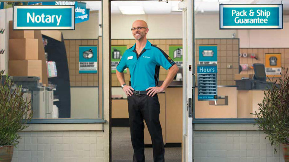 Franchisee standing in front of store