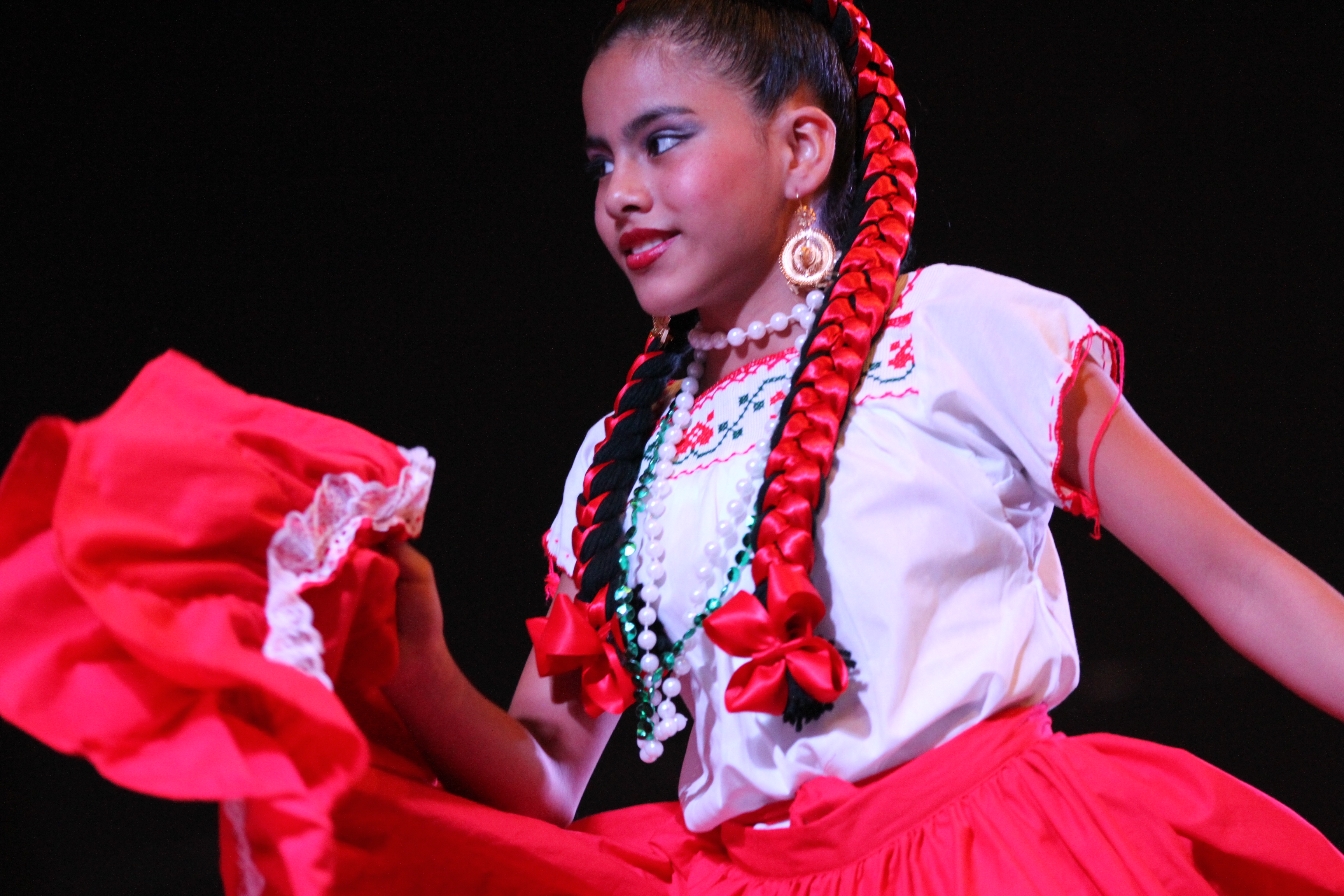 girl dressed in traditional Mexican heritage outfit performs at the Mexican Heritage Fiesta in Port Arthur, Texas